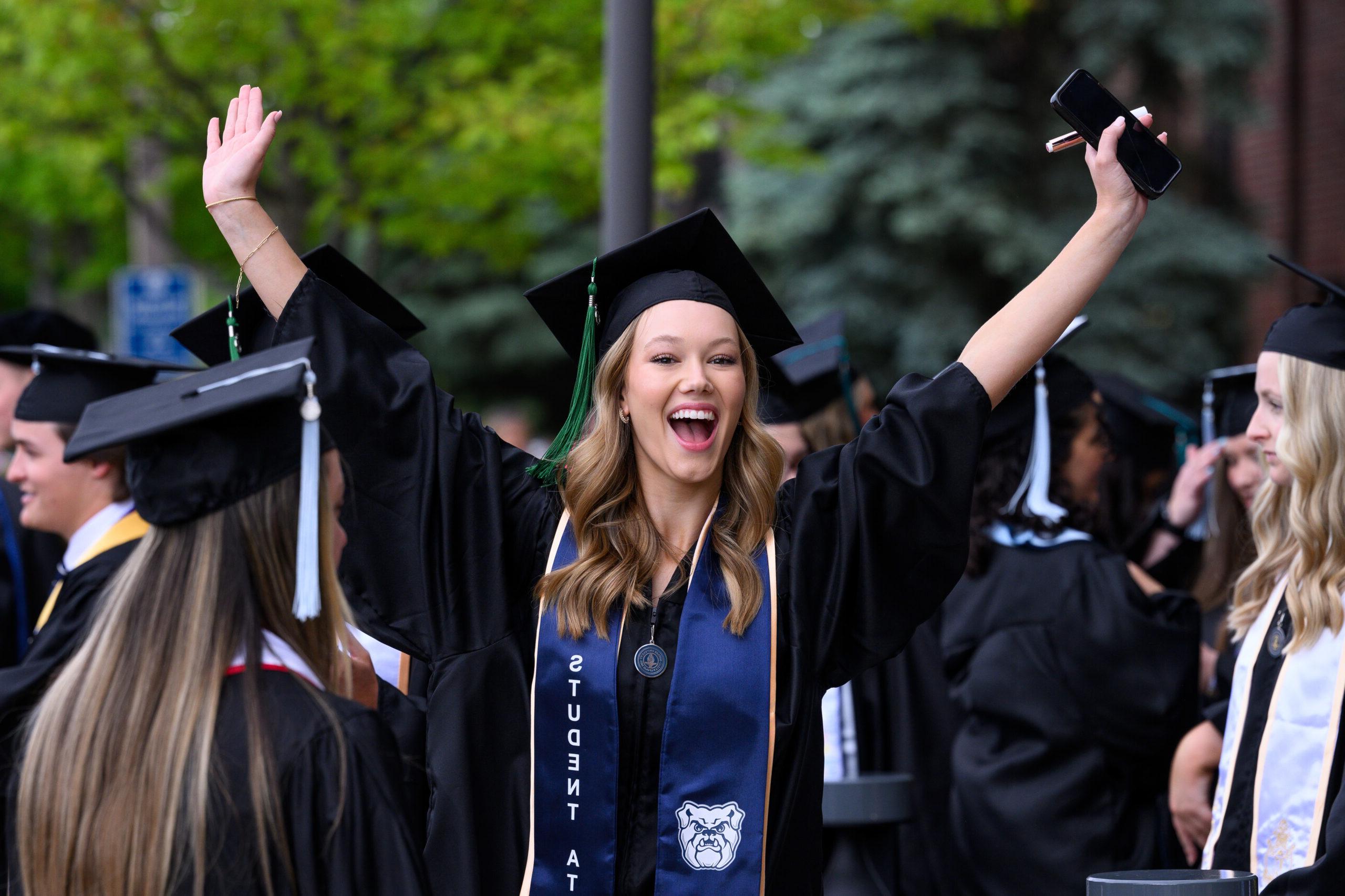 Female Butler graduate excited at Commencement ceremony.